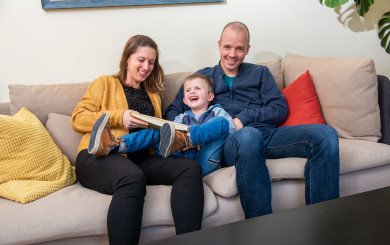 Laura on the couch with her son Enzo and husband