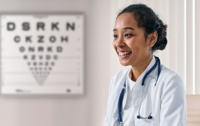 Ophthalmologist at her office with logmar chart on wall