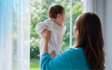 Mother and baby looking out of the window
