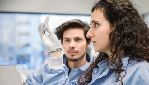 Two scientist in ProQRs lab, inspecting the contents of a test tube.