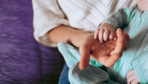 Mother holding baby's hand