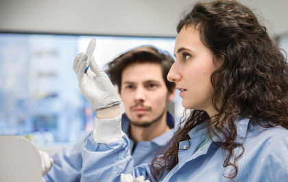 Two scientist in ProQRs lab, inspecting the contents of a test tube.