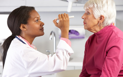 The eyes of an elderly woman are examined by a female doctor
