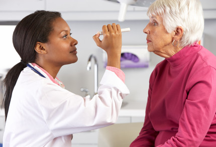 The eyes of an elderly woman are examined by a female doctor