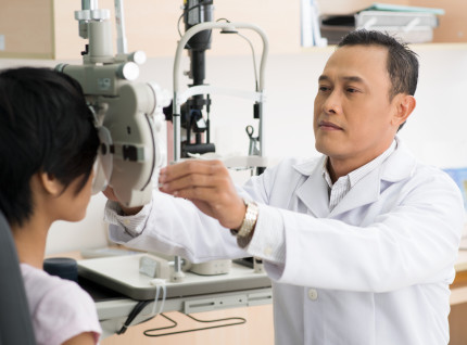 An ophthalmologist performing an eye exam.