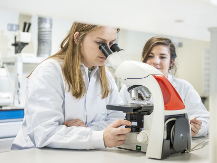 Two ProQRians looking at cell cultures