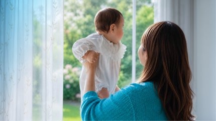 Mother and baby looking out of the window