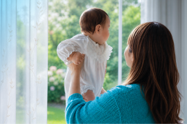 Mother and baby looking out of the window