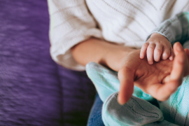 Mother holding baby's hand